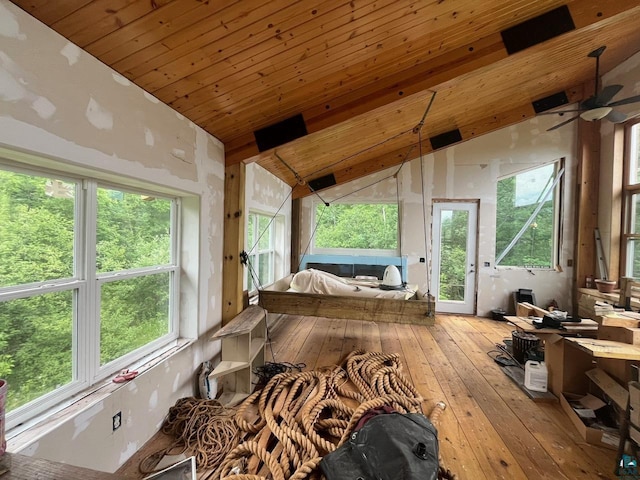 sunroom featuring wood ceiling, ceiling fan, lofted ceiling, and plenty of natural light