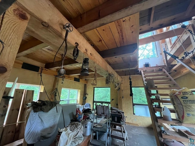 miscellaneous room featuring ceiling fan, beam ceiling, wooden ceiling, and a healthy amount of sunlight