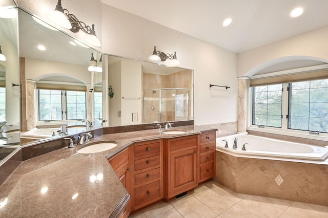 bathroom featuring tile patterned floors, plenty of natural light, vanity, and independent shower and bath