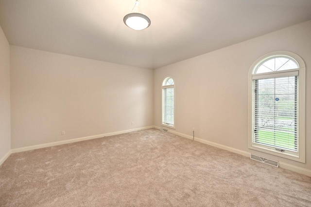 carpeted empty room featuring a healthy amount of sunlight