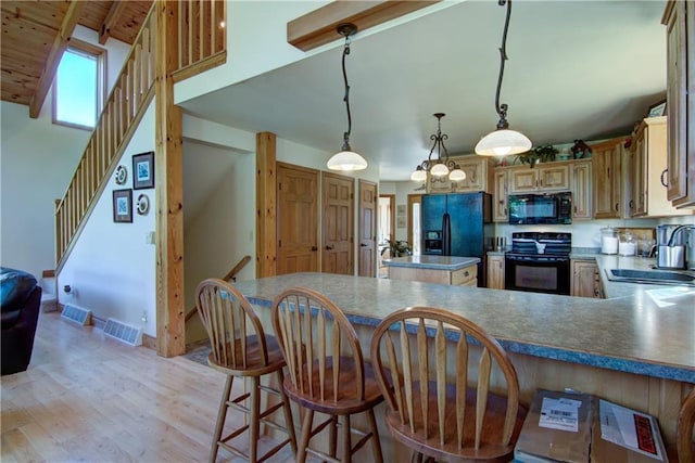 kitchen featuring wooden ceiling, black appliances, sink, hanging light fixtures, and a kitchen bar