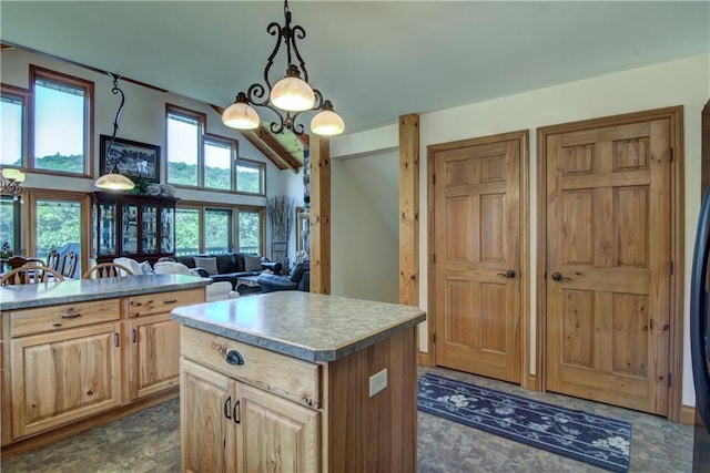 kitchen with a kitchen island, a healthy amount of sunlight, and decorative light fixtures