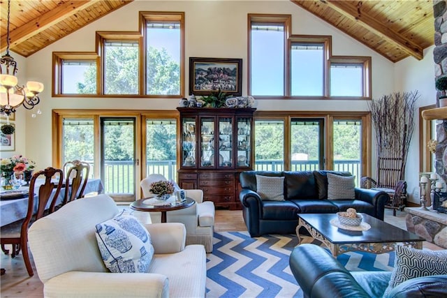 living room with a chandelier, a towering ceiling, light hardwood / wood-style floors, and wooden ceiling