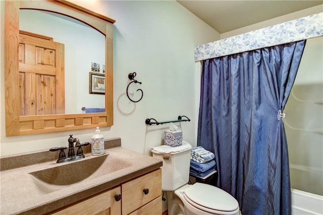 full bathroom with shower / bath combo, vanity, and toilet