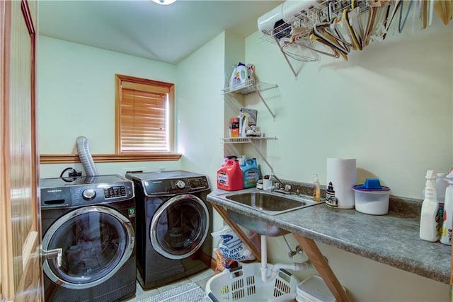 clothes washing area featuring tile patterned floors, sink, and washing machine and clothes dryer