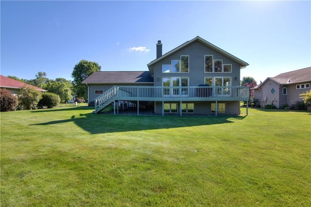 back of house featuring a deck and a yard