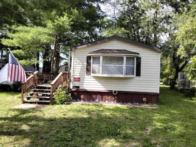 back of property with a lawn and a wooden deck