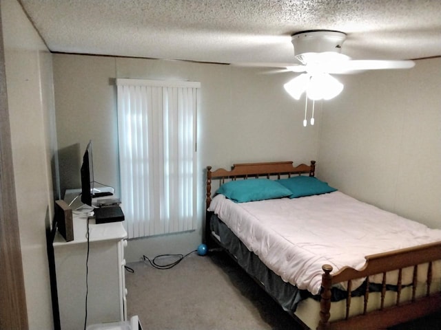 carpeted bedroom with ceiling fan, a textured ceiling, and multiple windows