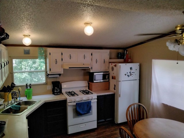 kitchen with a textured ceiling, white appliances, ceiling fan, sink, and white cabinetry