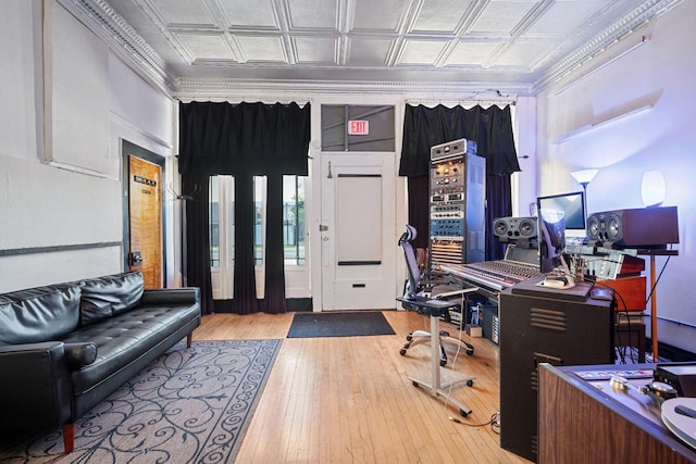 office area with hardwood / wood-style floors and ornamental molding