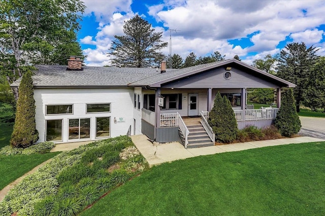 single story home with covered porch and a front yard