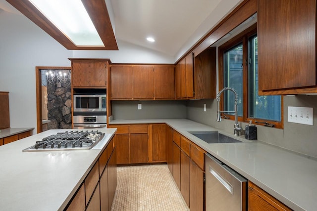 kitchen with light tile patterned flooring, lofted ceiling, sink, and appliances with stainless steel finishes