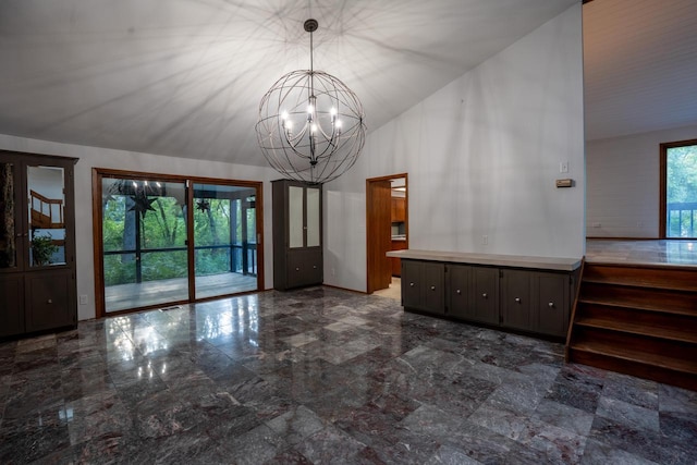 interior space with high vaulted ceiling and a chandelier