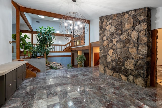 interior space with a notable chandelier and lofted ceiling with beams