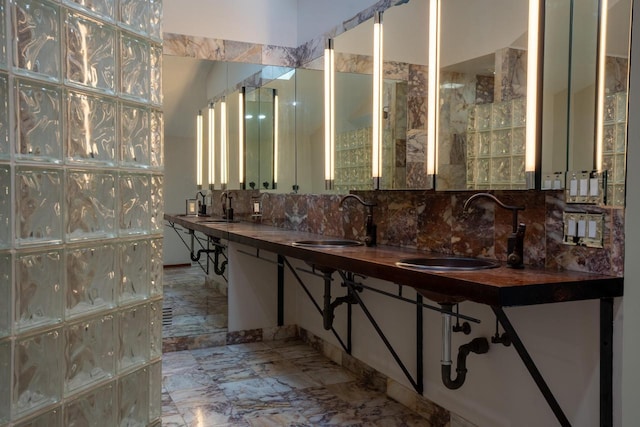 bathroom with vanity and tasteful backsplash