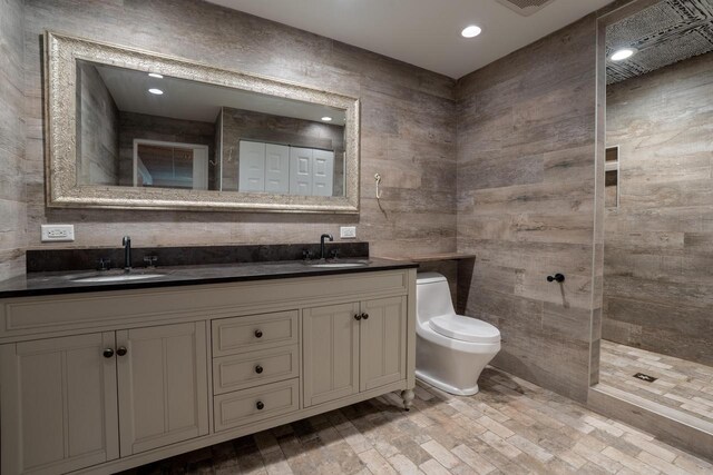 bathroom with a shower, vanity, hardwood / wood-style flooring, and toilet