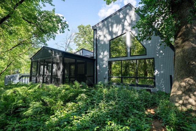 back of property featuring a sunroom