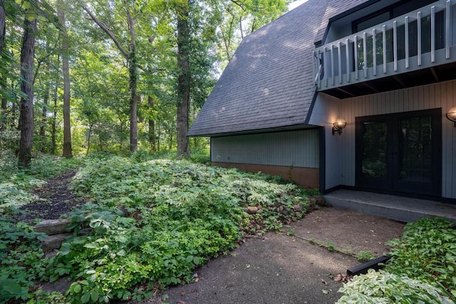 exterior space with a balcony and french doors