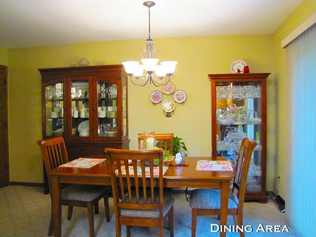 dining room with carpet flooring and a notable chandelier