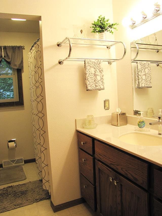 bathroom featuring tile patterned flooring and vanity