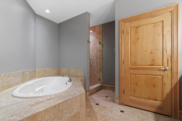 bathroom featuring tile patterned flooring and independent shower and bath