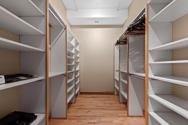 walk in closet featuring hardwood / wood-style flooring