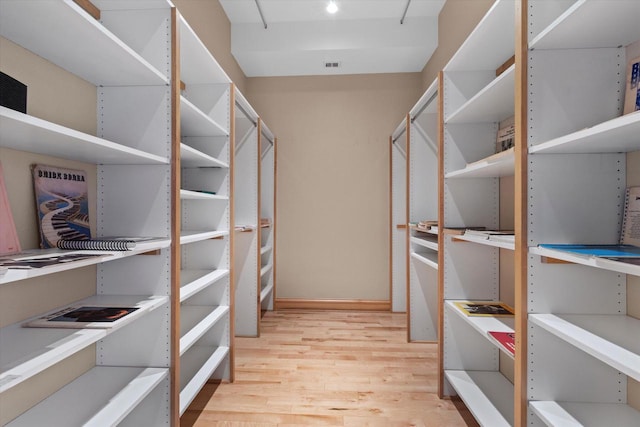 spacious closet with light hardwood / wood-style flooring