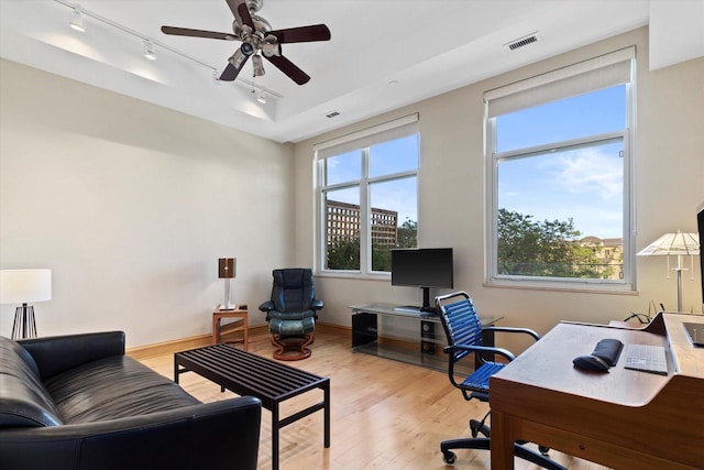 office area with ceiling fan, a wealth of natural light, and light hardwood / wood-style flooring