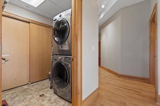 clothes washing area featuring stacked washer / drying machine