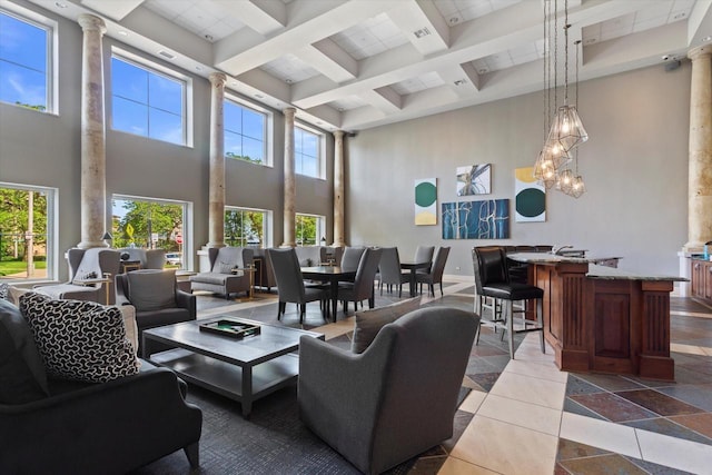 interior space featuring beam ceiling, ornate columns, a towering ceiling, and coffered ceiling