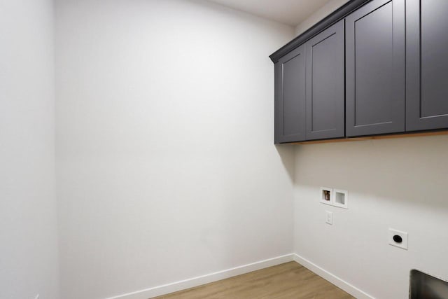 clothes washing area with electric dryer hookup, cabinets, light wood-type flooring, and hookup for a washing machine