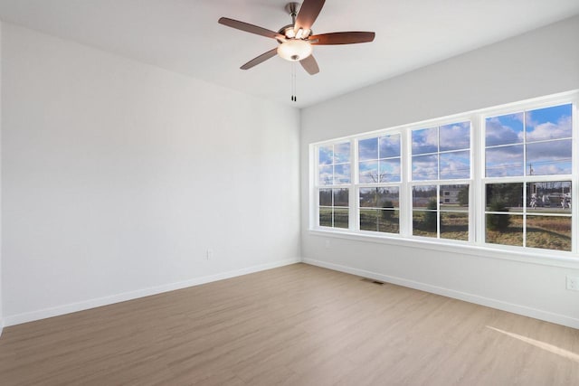 empty room with light hardwood / wood-style floors and ceiling fan