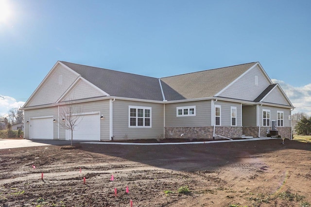 view of front facade with cooling unit and a garage