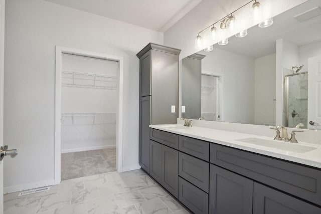 bathroom featuring vanity and a shower with shower door