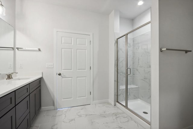 bathroom with vanity and a shower with shower door