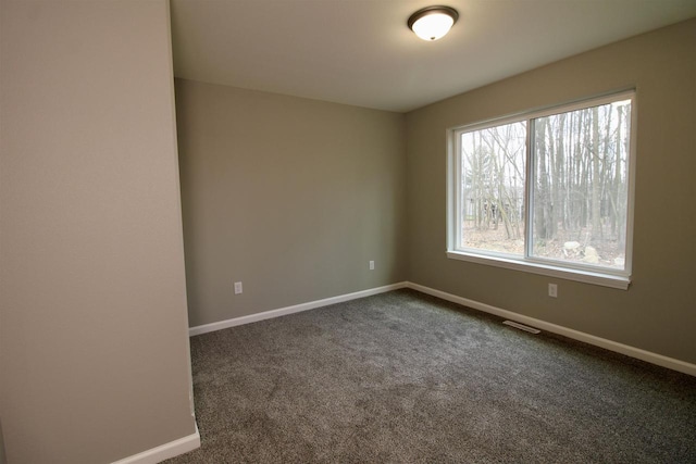 empty room with dark colored carpet