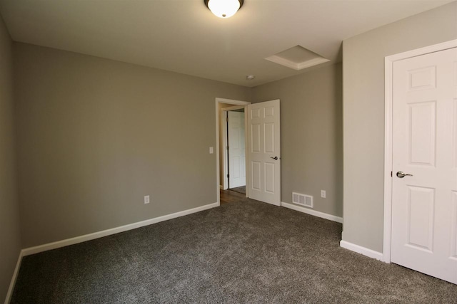 unfurnished bedroom featuring dark carpet