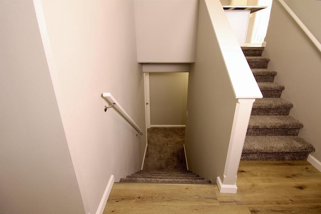 stairs featuring hardwood / wood-style flooring