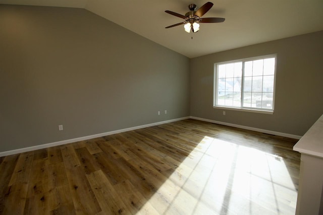 spare room featuring ceiling fan, light wood-type flooring, and lofted ceiling