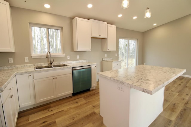 kitchen with white cabinets, pendant lighting, a center island, and stainless steel dishwasher