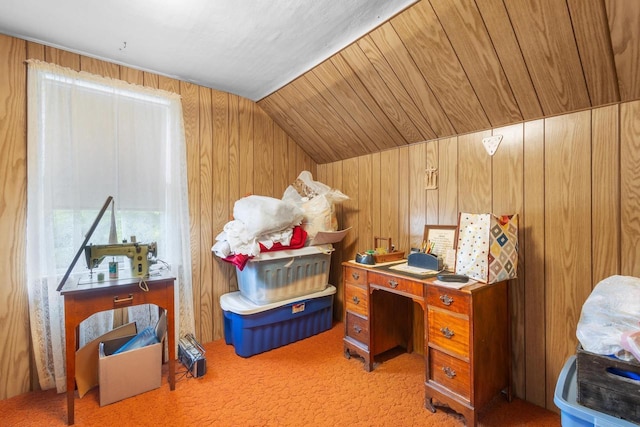 carpeted office featuring vaulted ceiling and wooden walls