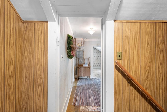 corridor featuring wooden walls