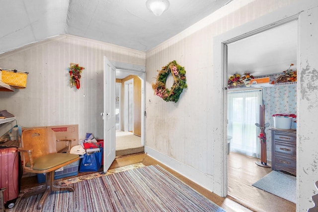 interior space with vaulted ceiling and ornamental molding