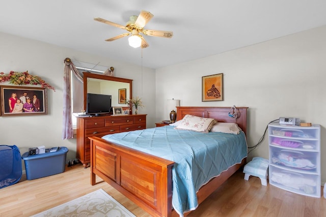 bedroom with light hardwood / wood-style flooring and ceiling fan