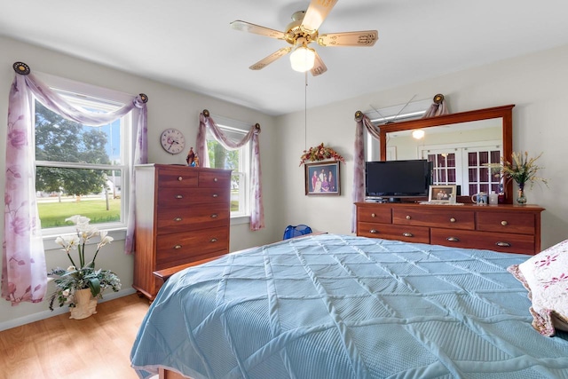 bedroom with ceiling fan and light wood-type flooring