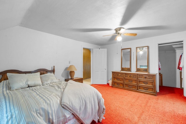 carpeted bedroom featuring ceiling fan, lofted ceiling, and a closet