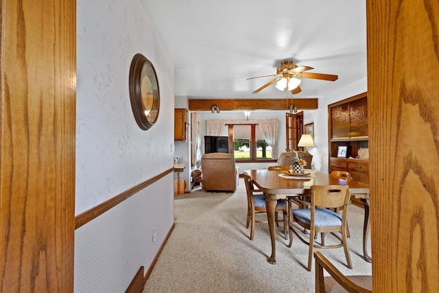 carpeted dining area featuring ceiling fan