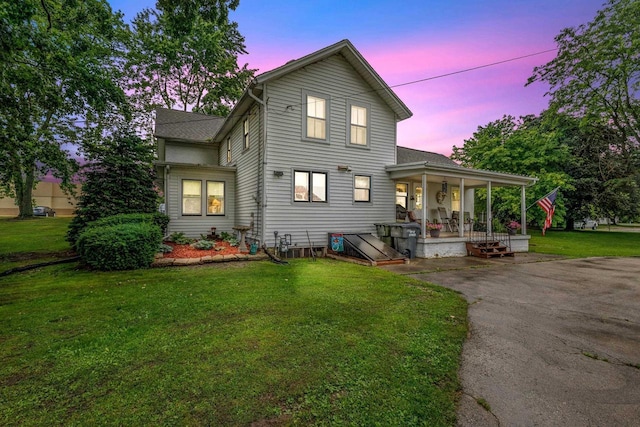 view of front of house with a porch and a lawn