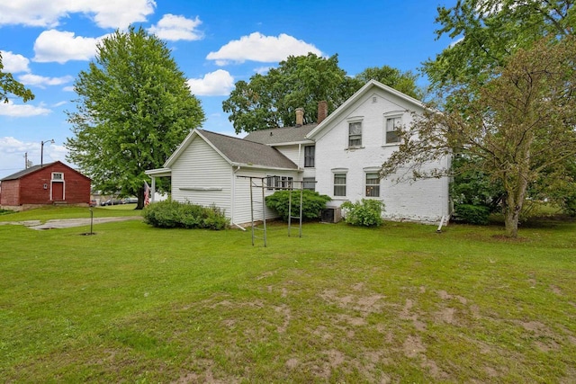 rear view of property featuring a lawn