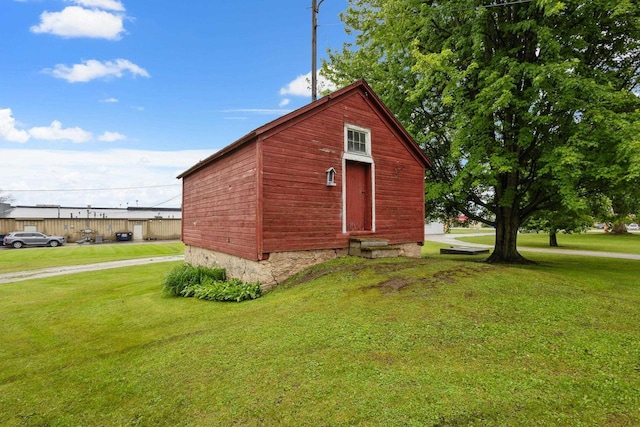 view of outbuilding featuring a lawn